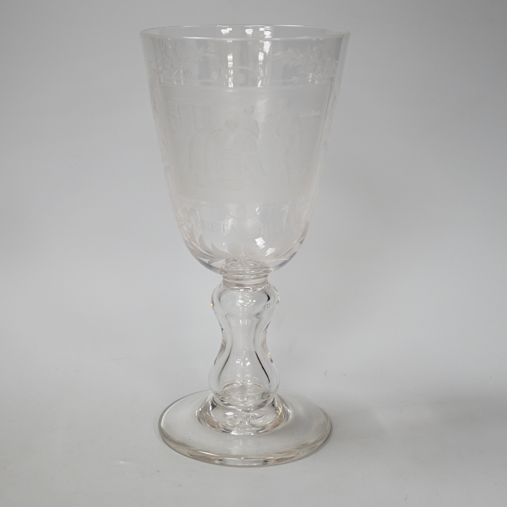 A lead crystal commemorative Gretna Green goblet, with fine engraving of a blacksmith and couple signing the register on an anvil, the panel surrounded by floral engraving, ‘GRETNA GREEN’ below, 23.9cm high